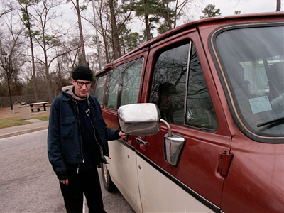 Jim with his van at a rest stop.